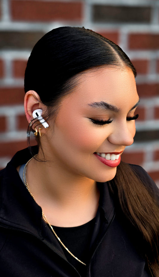 Photo of a girl wearing AirPods 4 on the right ear.