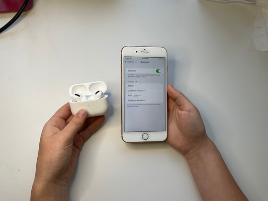 Photo of someone pairing their AirPods to their iPhone.
