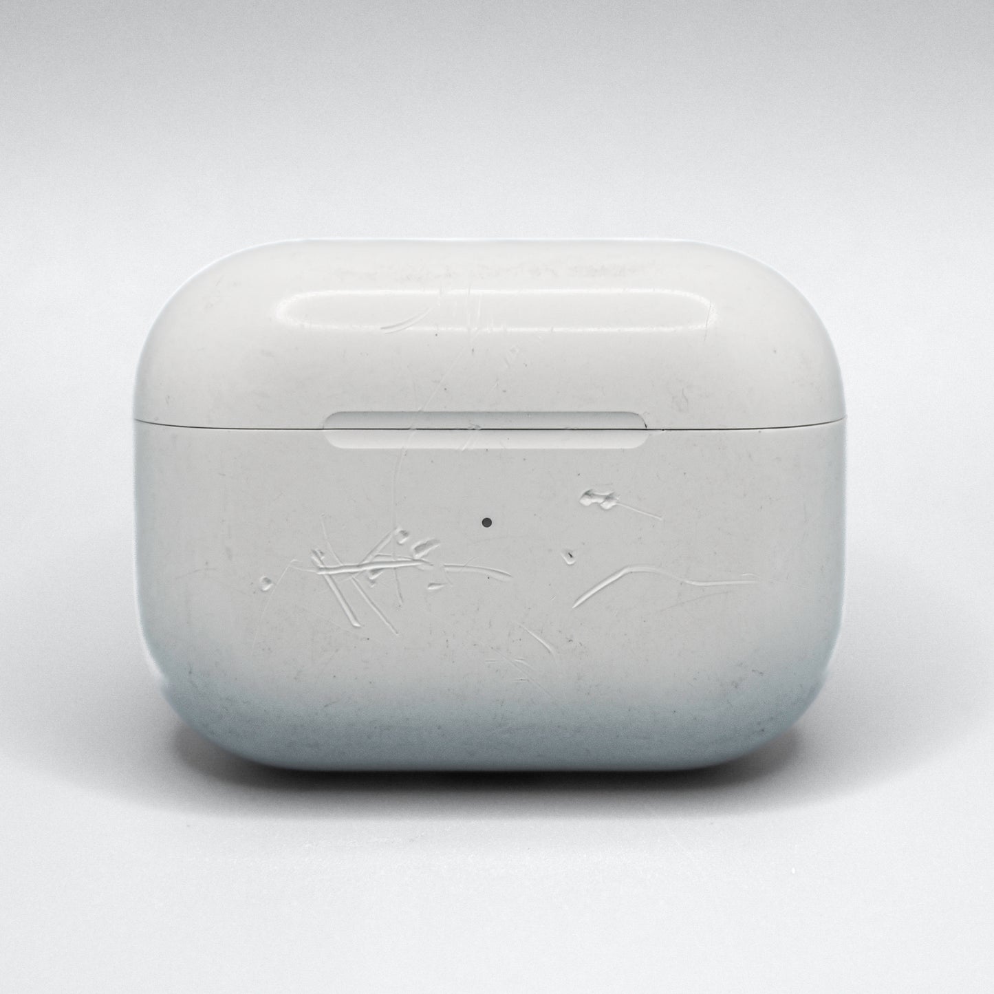 Well loved cases may have scratches, bite marks, or engravings. This is an example of damage on an AirPods Pro 1 Case.
