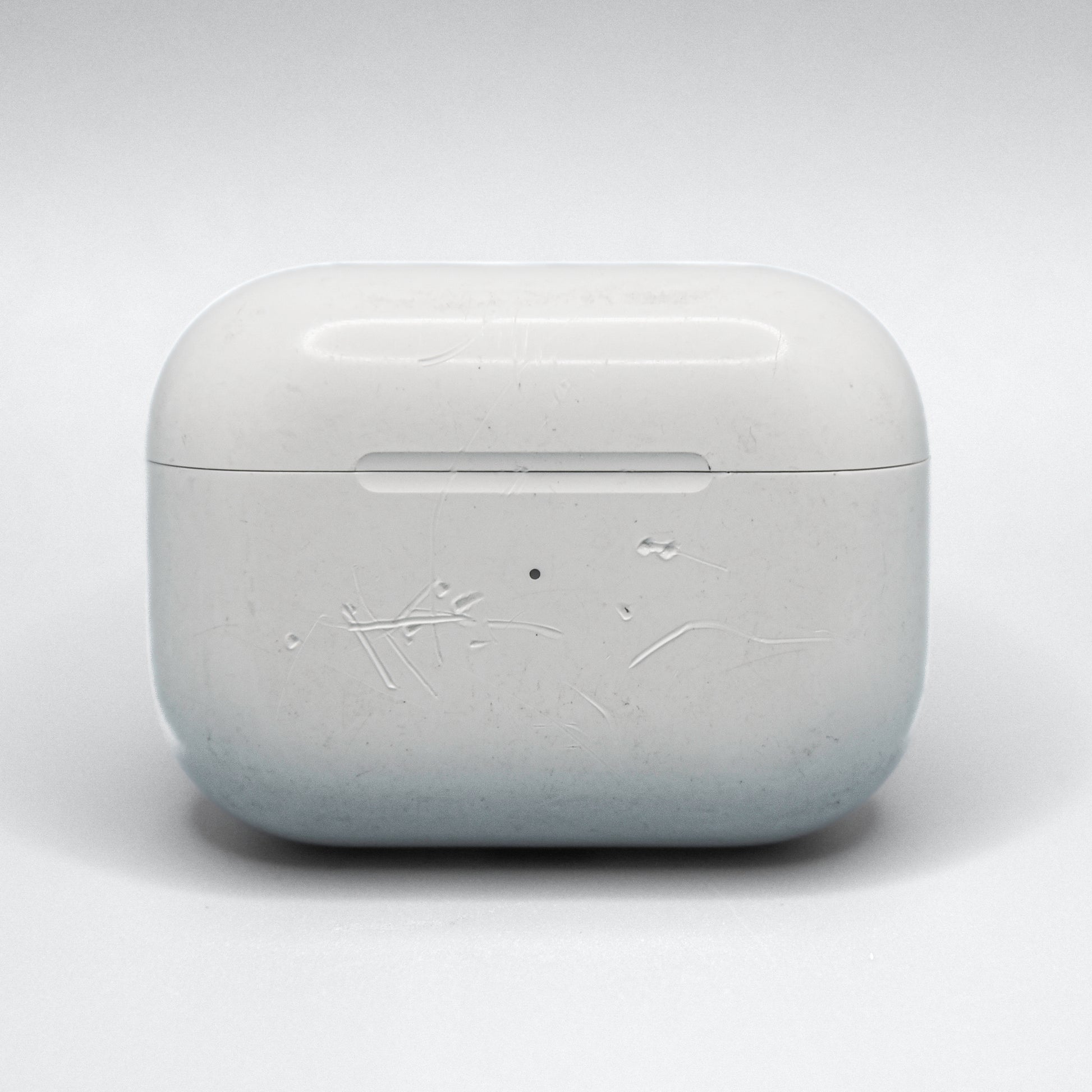 Well loved cases may have scratches, bite marks, or engravings. This is an example of damage on an AirPods Pro 1 Case.
